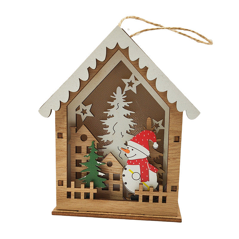 Illuminated wooden Christmas house as tree ornament