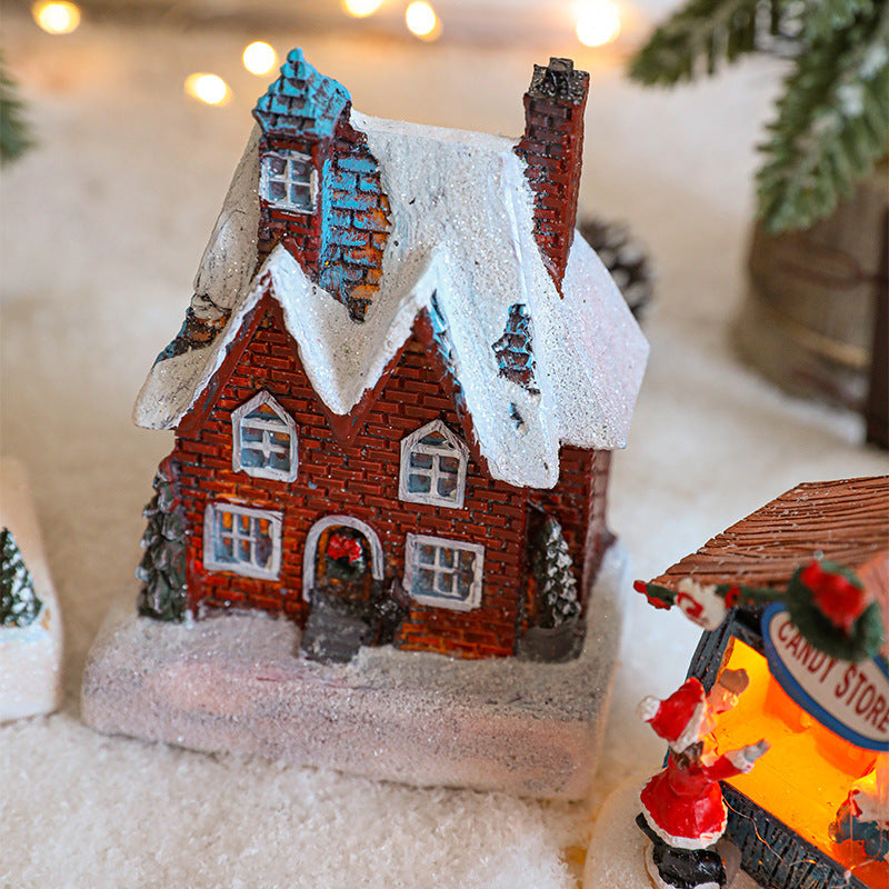 Illuminated Christmas house made of resin for table decoration