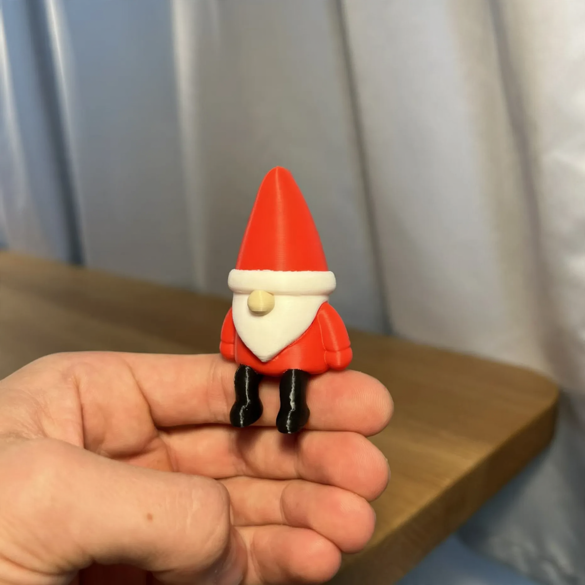 Miniature Santa Claus figure, sitting