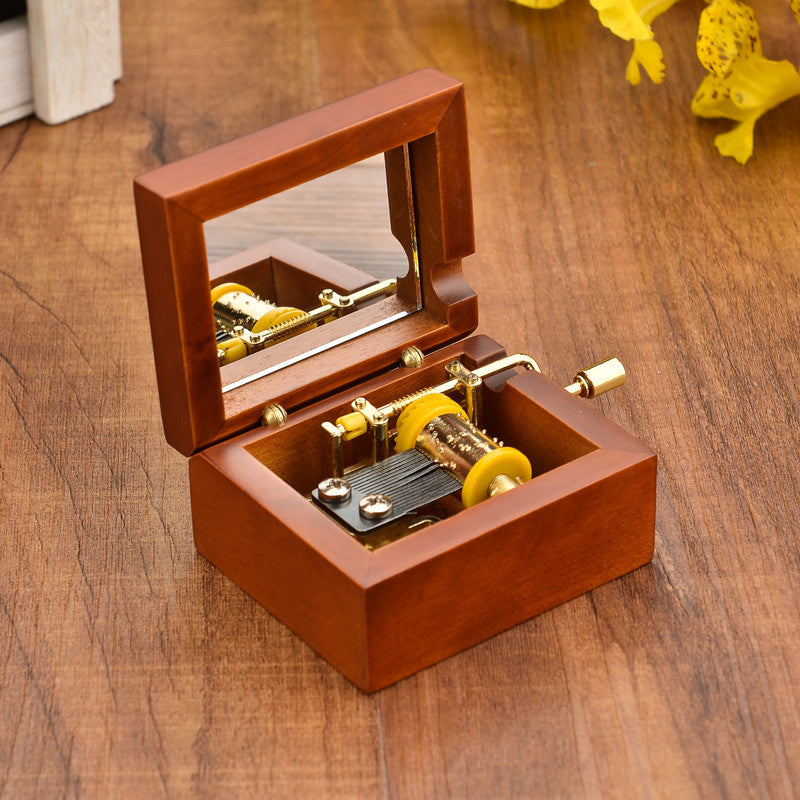 Wooden music box with hand crank