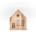 Christmas wooden house with lighting as table decoration