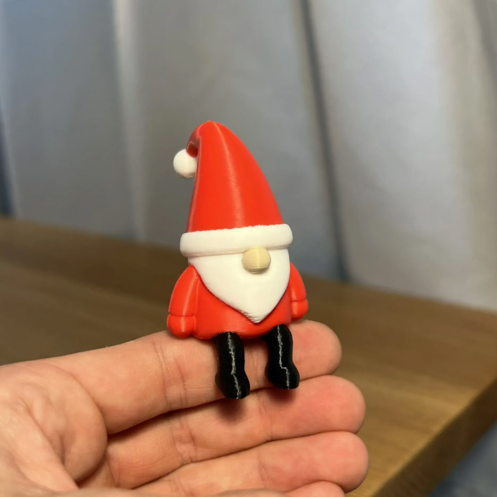 Miniature Santa Claus figure, sitting