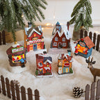 Illuminated Christmas house made of resin for table decoration