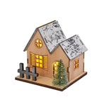 Illuminated wooden house for festive table decoration