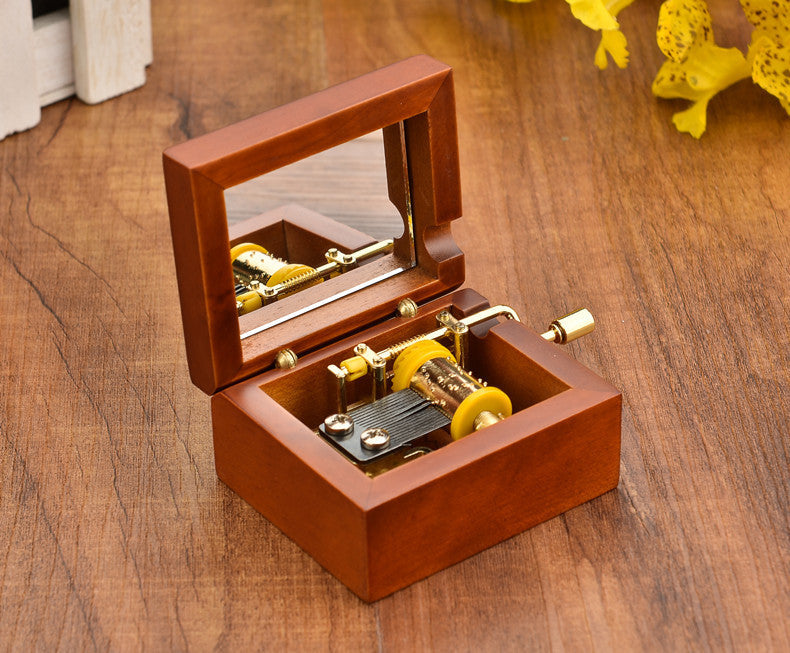 Wooden music box with hand crank