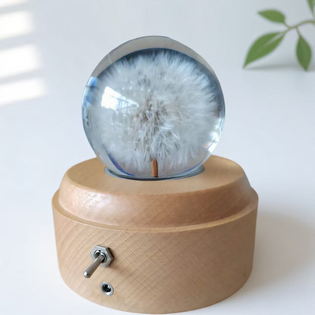 Crystal ball music box with rotating base and dried flowers