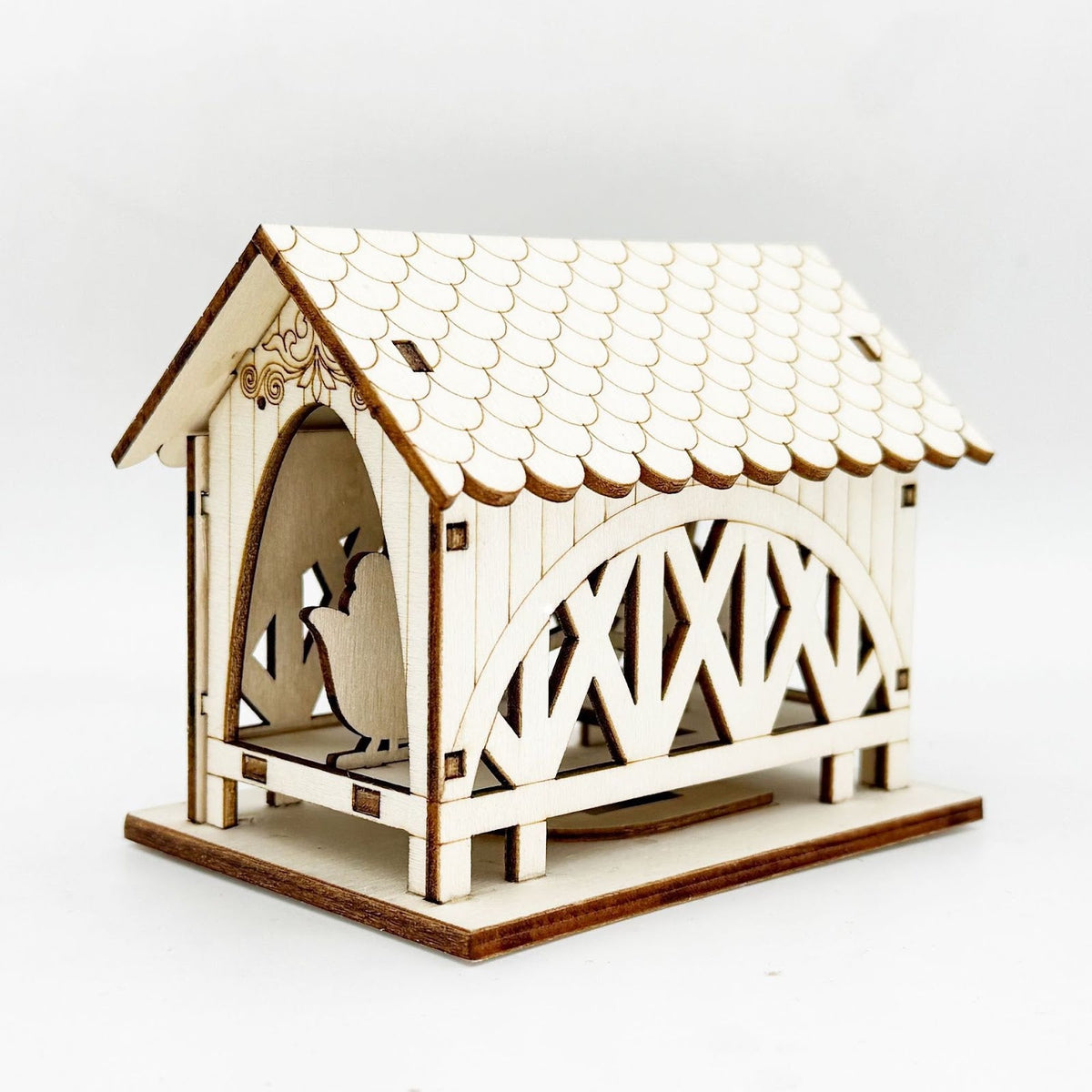 Illuminated wooden house with bridge