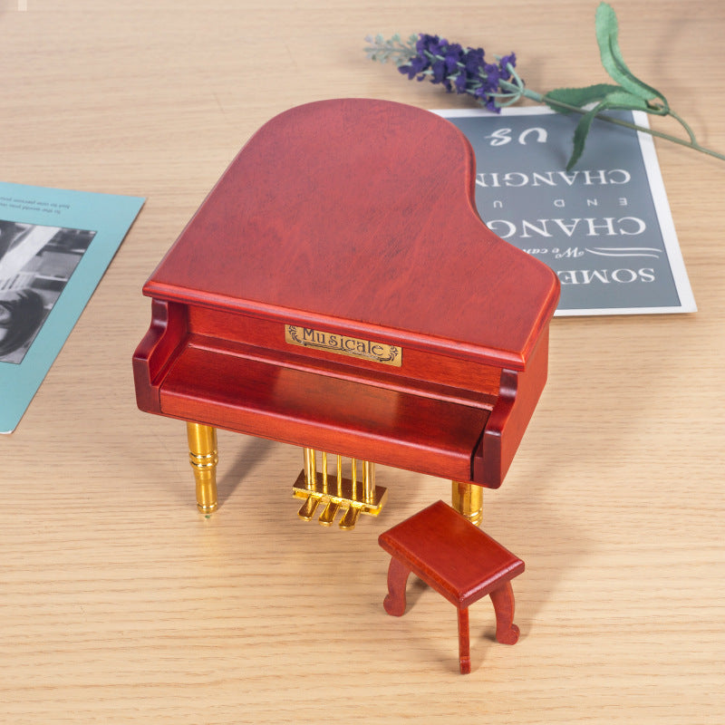 Wooden music box in piano shape with metal feet